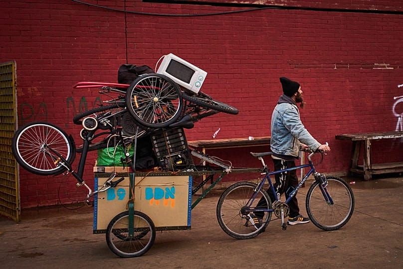 A migrant carries his belongings at an abandoned school building where hundreds of undocumented migrants had been living, in Badalona, near Barcelona, Spain, Dec. 17. 2025