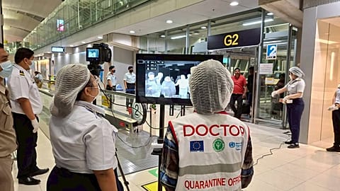 Doctors watch thermal scanning of travelers from west Bengal, India at the Suvarnabhumi International Airport in Thailand.t