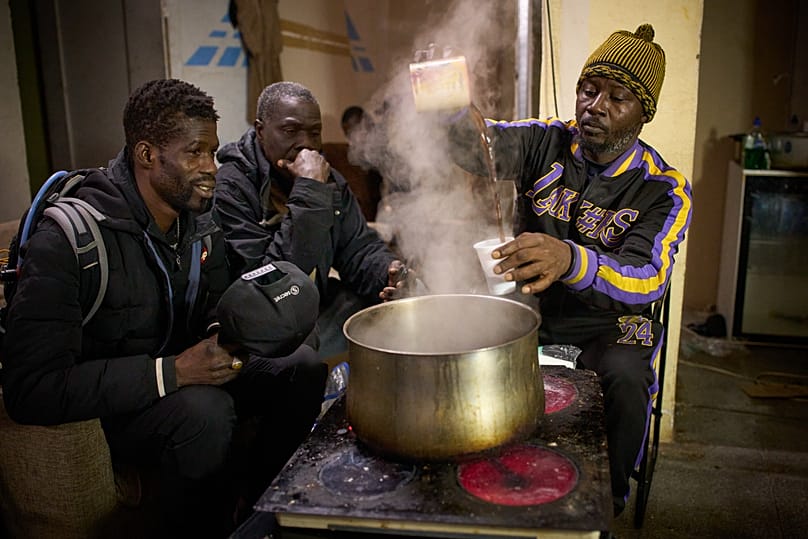Migrants from Senegal gather to drink coffee at a makeshift bar in Badalona, 17 December, 2025