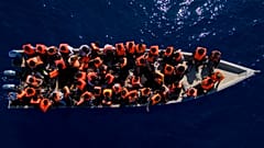 File photo of migrants from Eritrea, Libya and Sudan sailing a wooden boat before being rescued about 30 miles north of Libya, Saturday 17 June 2023.