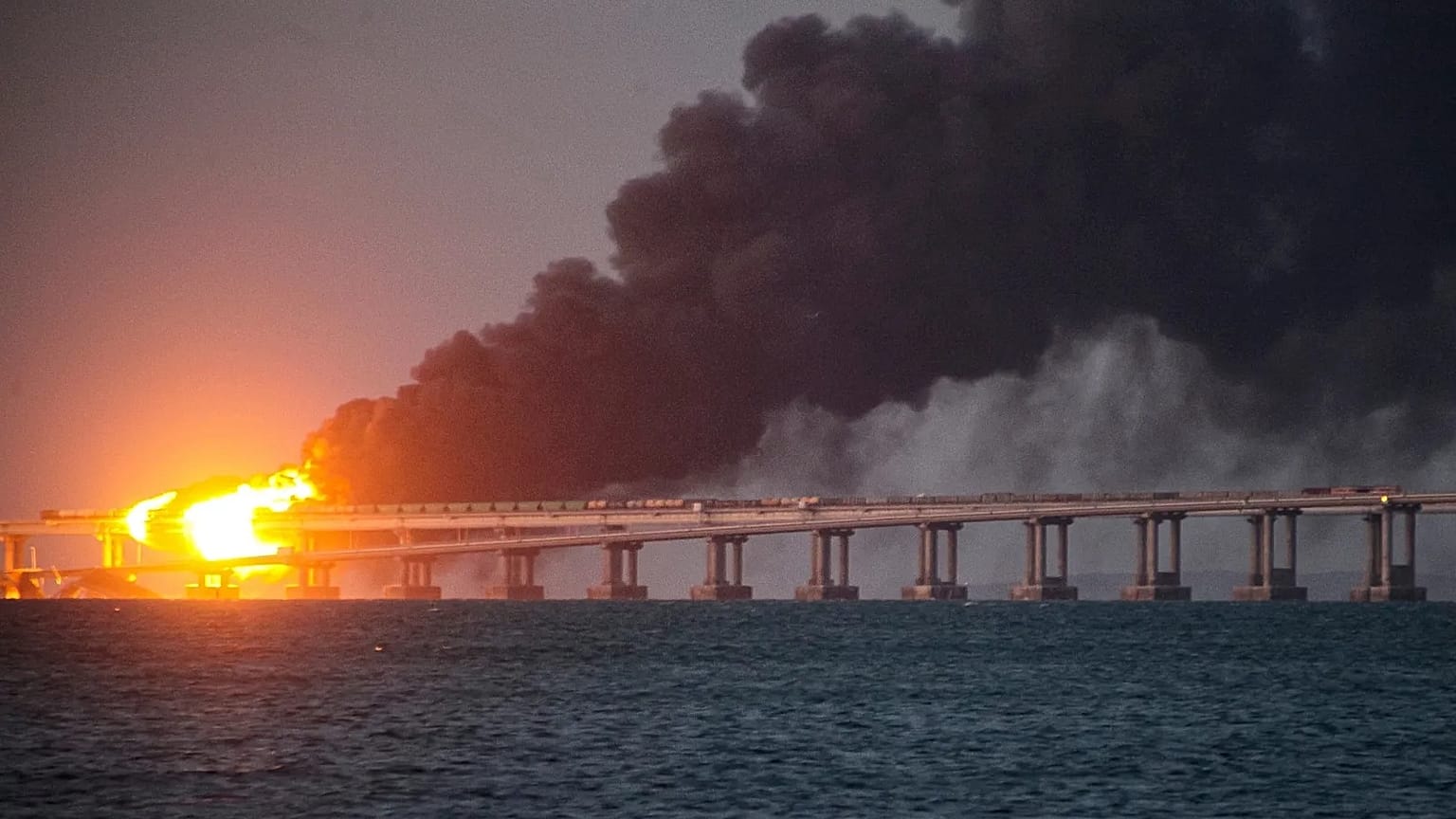 Flames and smoke rise from the Kerch Bridge connecting the Russian mainland and the Crimean peninsula, 8 October, 2022
