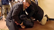 A man is tackled to the ground after spraying an unknown substance on US Congresswoman Ilhan Omar during a town hall in Minneapolis, 27 January 2026