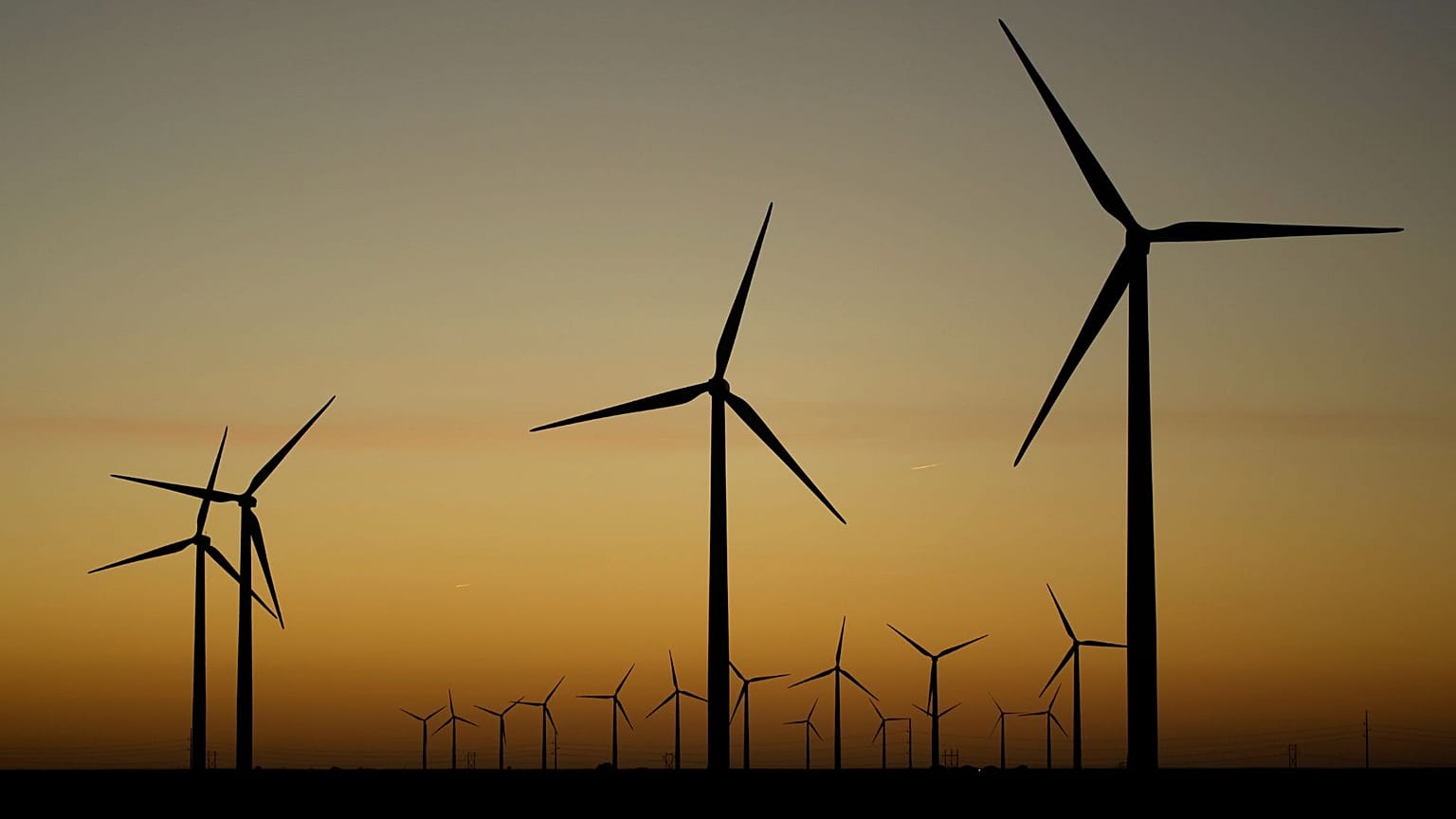 FILE - Wind turbines stretch across the horizon at dusk at the Spearville Wind Farm, Sept. 29, 2024, near Spearville, Kan. 