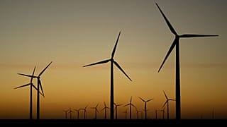 FILE - Wind turbines stretch across the horizon at dusk at the Spearville Wind Farm, Sept. 29, 2024, near Spearville, Kan. 