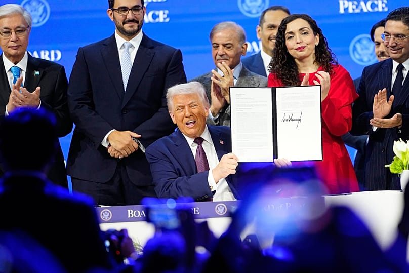 US President Donald Trump holds the charter of the World Economic Forum in Davos, 22 January, 2026