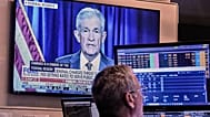 A video of Federal Reserve Chair Jerome Powell plays on a screen on the floor of the New York Stock Exchange, 12 January, 2026
