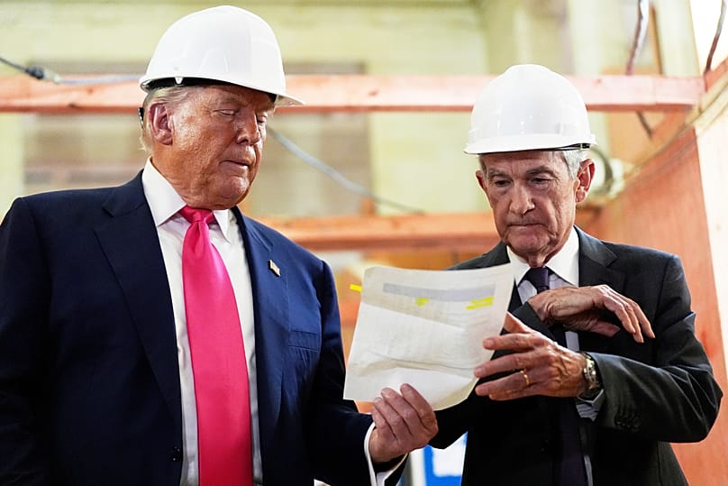 Federal Reserve Chairman Jerome Powell and US President Donald Trump look over a document of cost figures during a visit to the Federal Reserve, 24 July, 2025