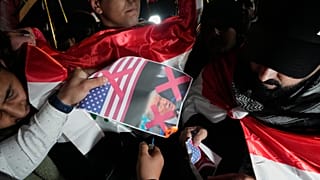 أضرم متظاهر النار في صورة للعلم الأمريكي والرئيس دونالد ترامب خلال احتجاج على تحذير ترامب من أن الولايات المتحدة ستتوقف عن دعم البلاد إذا عاد رئيس وزرائها السابق، نوري المالكي