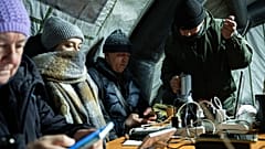Menschen wärmen sich auf und laden ihre mobilen Geräte in Kiew während des Stromausfalls, der durch regelmäßige russische Luftangriffe auf das Stromnetz des Landes verursacht wurde