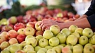 Apples are displayed at a farmers' market.