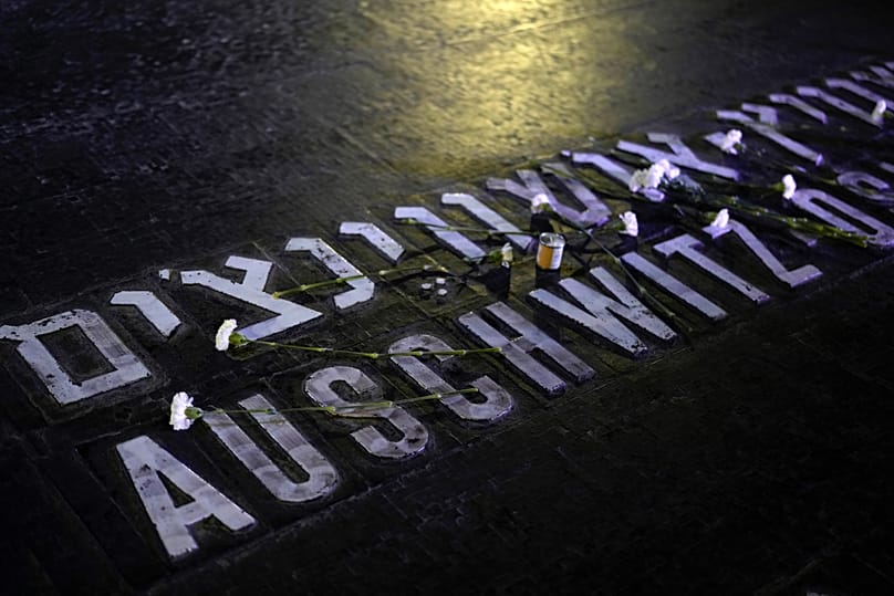 FILE:  Flowers are placed on the name of the Auschwtz concentration camp, marking Holocaust Remembrance Day in the Hall of Remembrance at Yad Vashem, 2024