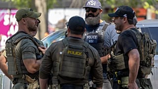 Federal officers speak at a checkpoint, including officers from ICE and HSI, in Washington Saturday, Aug. 30, 2025.