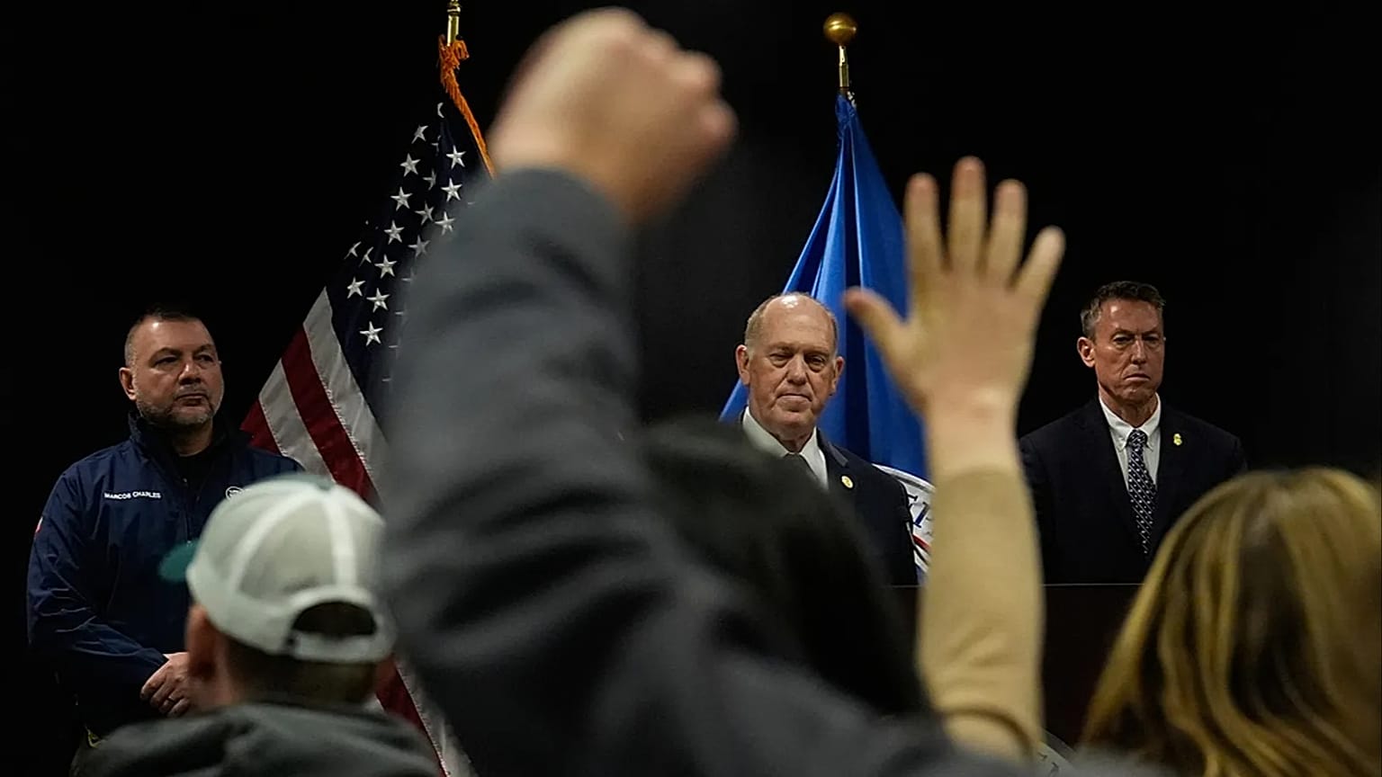 Members of the media raise their hands to ask questions as White House border czar Tom Homan holds a news conference in Minneapolis, 29 January 2026