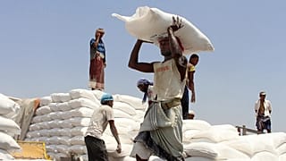 Men deliver UN World Food Program aid in Aslam, 21 September, 2018 