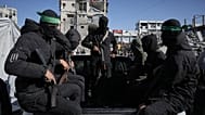 Hamas militants arrive at a site where they are searching for the remains of hostages in Jabalia, 1 December, 2025