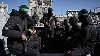 Hamas militants arrive at a site where they are searching for the remains of hostages in Jabalia, 1 December, 2025
