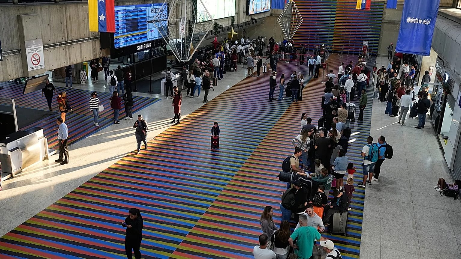 Passengers wait to check in at Simon Bolivar International Airport in Maiquetia, 5 January, 2026