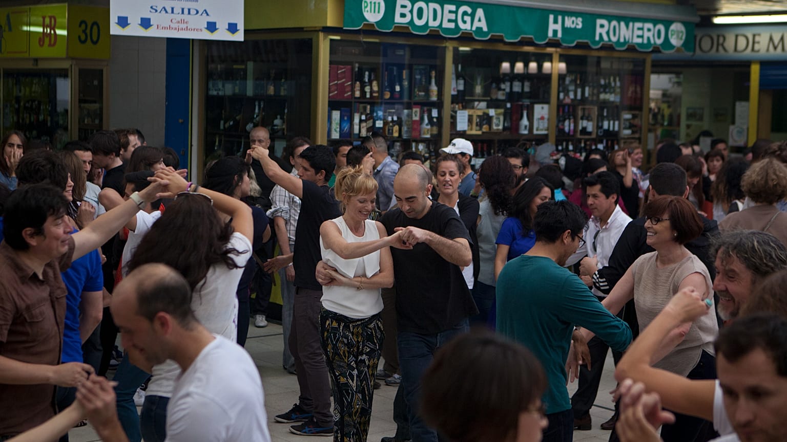 FILE. People dance in the San Fernando food market in Madrid, Spain, Sunday. 20 April 2014.