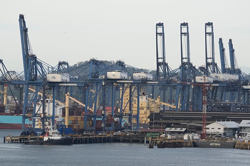 Cranes load a cargo ship at the Panama Canal's Port of Balboa managed by CK Hutchison Holdings in Panama City, 13 March, 2025