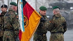 Brigadier General Christoph Huber commander of Armoured Brigade 45 "Lithuania" hands over the troop flag to Lieutenant Colonel Rayk Engel
