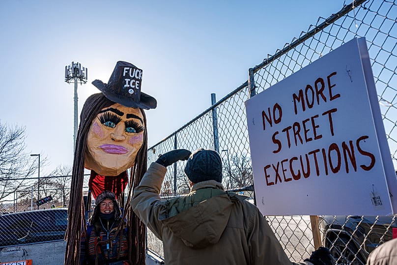 A protester wearing a large puppet head stands outside the Whipple Building during a demonstration against ICE in Minneapolis, 29 January, 2026