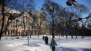 People walk along Red Square on a frosty day in Moscow, Friday, Jan. 30, 2026