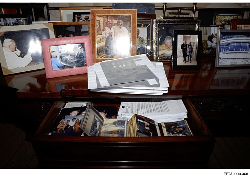 A desk with a drawer open and photographs during a search of Jeffrey Epstein's home in New York, 6 July, 2019