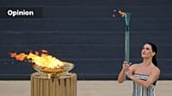 FILE: Greek actress Mary Mina, playing the role of High Priestess, lights a torch from the cauldron during the Olympic flame handover ceremony in Athens, 4 December 2025. 