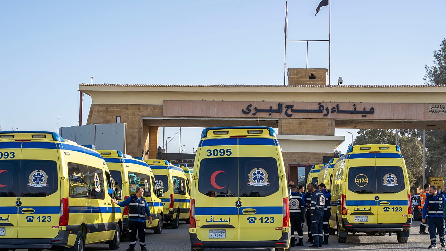 Ambulances line up to enter the Egyptian gate of the Rafah crossing on the way to the Gaza Strip, in Rafah