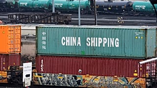 FILE - A Norfolk Southern freight pulls a consist of shipping containers pulls through the Conway Terminal in Freedom, Pa., 10 April 2025.