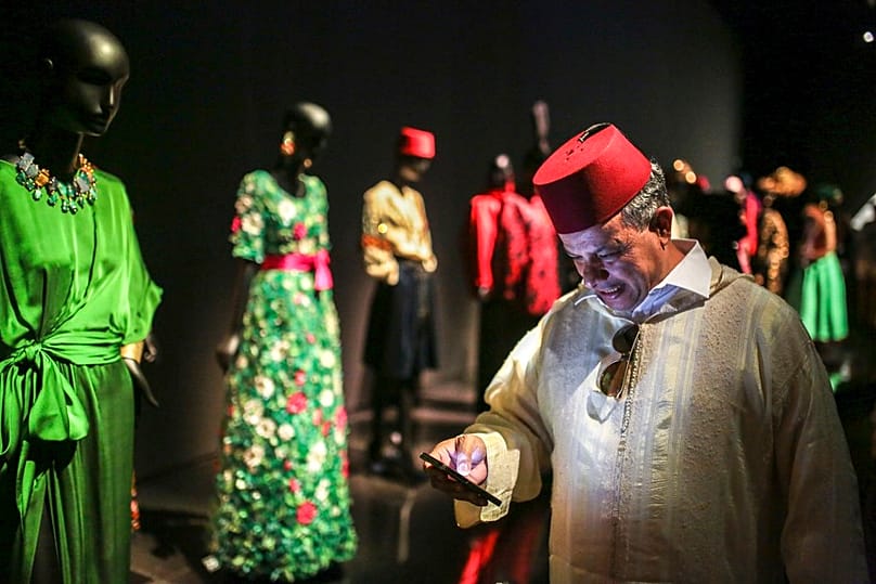 A visitor checks his phone inside the Yves Saint Laurent museum, in Marrakesh, Morocco, Thursday, Oct. 19, 2017. 