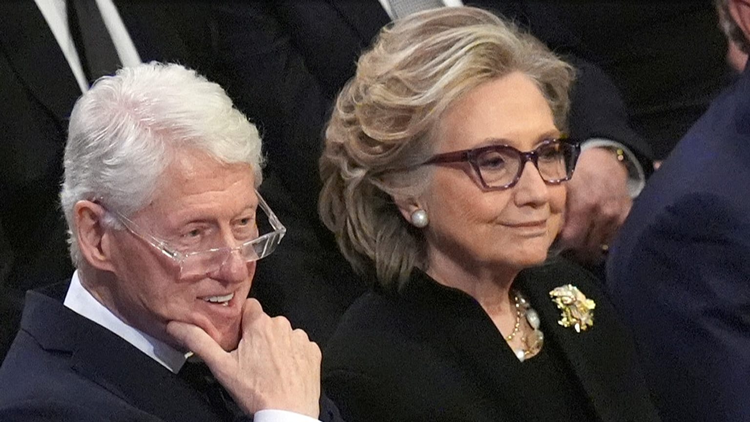 FILE - Former President Bill Clinton and former Secretary of State Hillary Clinton listen during a state funeral for former President Jimmy Carter, in Washington, Jan. 9, 2025