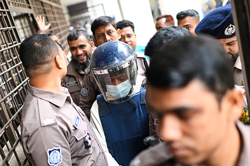 Police escort accused Khurshes Alam into the courtroom following verdict that sentenced Sheikh Hasina to 10 years in prison in graft cases, in Dhaka, Monday, Feb. 2, 2026