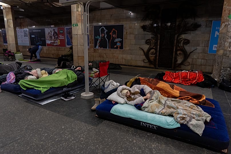 People take shelter in a metro station, being used as a bomb shelter, during a Russian drones attack in Kyiv, Ukraine, Tuesday, Feb. 3, 2026