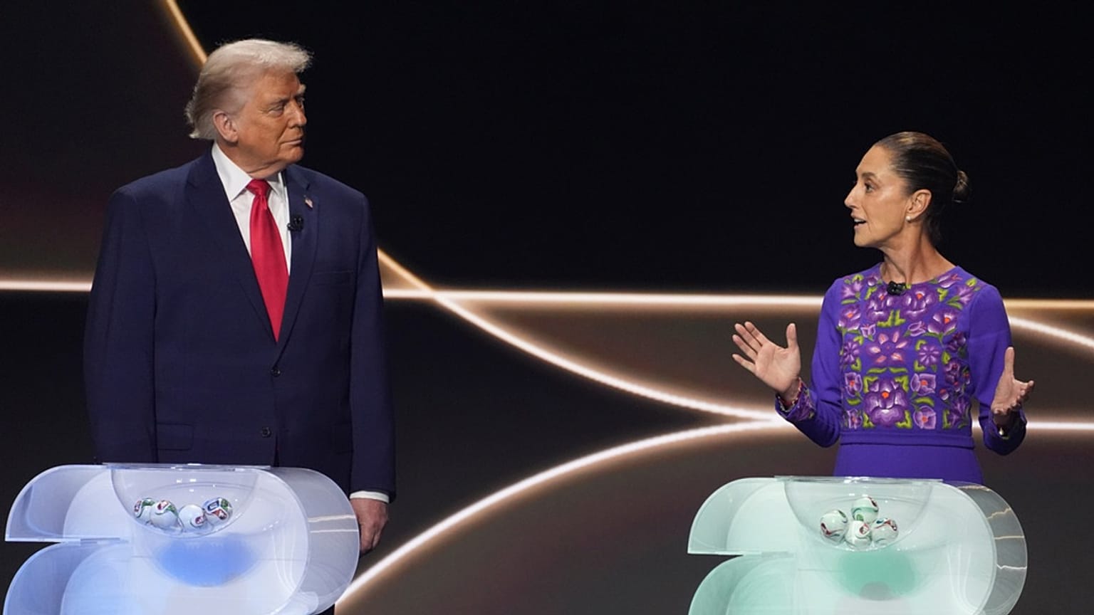 Mexican President Claudia Sheinbaum speaks as President Donald Trump stands on stage during the draw for the 2026 World Cup at the Kennedy Center in Washington, Dec. 5, 2025