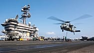MH-60S Sea Hawk helicopter hovering over the USS Carl Vinson aircraft carrier