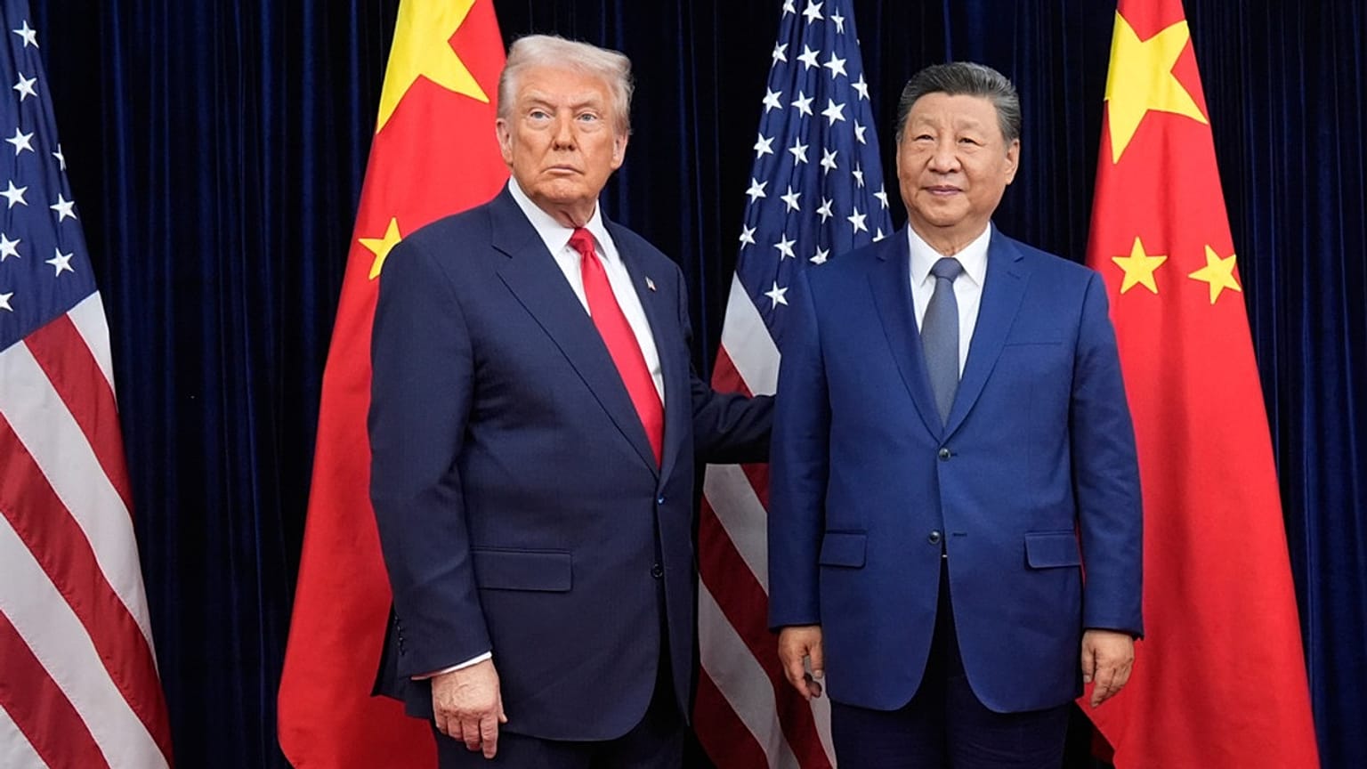 FILE - President Donald Trump, left, and Chinese President Xi Jinping pose ahead of their summit talk at Gimhae International Airport in Busan, South Korea, Oct. 30, 2025