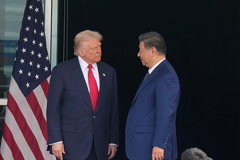 FILE - President Donald Trump and Chinese President Xi Jinping look at each other after their meeting at Gimhae International Airport in Busan, South Korea, Oct. 30, 2025