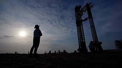 FILE - Visitors look on as SpaceX's Starship, the world's biggest and most powerful rocket, stands ready for a scheduled launch from Starbase in Boca Chica, Texas, 