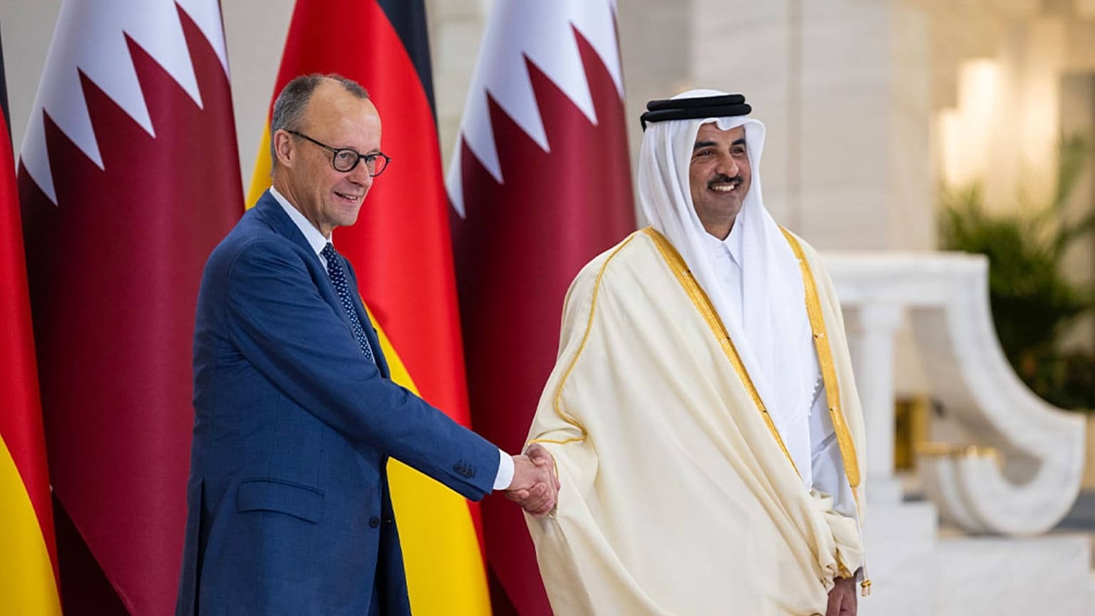 Qatar’s Amir Sheikh Tamim bin Hamad Al-Thani welcomes German Chancellor Friedrich Merz during talks in Doha.