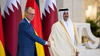 Qatar’s Amir Sheikh Tamim bin Hamad Al-Thani welcomes German Chancellor Friedrich Merz during talks in Doha.