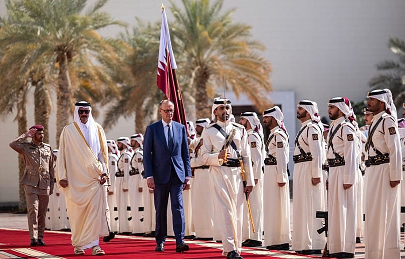 Merz walks with Qatar’s Amir Sheikh Tamim in Doha,