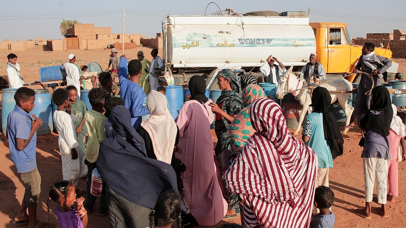 أشخاص يملأون المياه في نقطة توزيع مجانية بسبب انقطاع المياه في الخرطوم، السودان، الجمعة 30 يناير 2026. 
