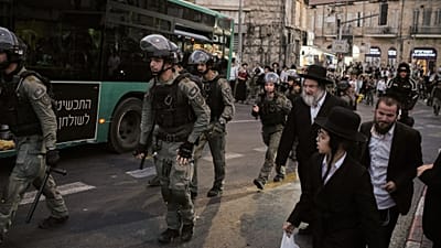 تحاول الشرطة تفريق مجموعة من الرجال اليهود المتشددين الذين أغلقوا شارعاً خلال احتجاج ضد التجنيد الإجباري، في القدس، الأربعاء 22 أكتوبر/تشرين الأول 2025. (صورة من وكالة أسوشييت