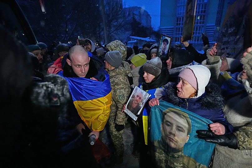 Ukrainian soldier walks in front of a crowd of people after returning from captivity after a POW exchange between Russia and Ukraine, Thursday, Feb. 5, 2026