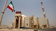 An Iranian flag flutters in front of the reactor building of the Bushehr nuclear power plant, just outside the southern city of Bushehr, Iran, Aug. 21, 2010. 