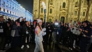 Ballet dancer Nicoletta Manni carries the Olympic torch flame, near the Duomo gothic cathedral, at the 2026 Winter Olympics, in Milan