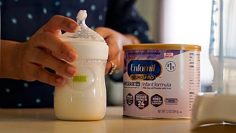 FILE: Olivia Godden prepares a bottle of baby formula for her infant son, Jaiden, Friday, May 13, 2022.