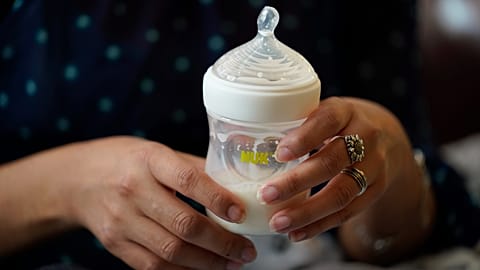 FILE: Olivia Godden holds a bottle of baby formula as she feeds her infant son.