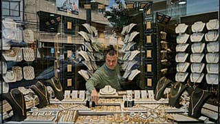 A Lebanese jeweler arranges gold ornaments at his shop's storefront in the Beirut suburb of Bourj Hammoud, Lebanon, Monday, Feb. 2, 2026. (AP Photo/Bilal Hussein)